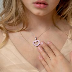 Looking for a special gift for your little princess? This gorgeous open heart pendant sparkles brightly with multiple pretty pink cubic zirconias. Crafted entirely of 925 sterling silver which is suitable for those with sensitive skin. This necklace rests on a beautiful matching link chain and comes neatly packaged in its own little gift box! Age Group: Lovely for Young Girls and Pre-Teens; Safe for Sensitive Skin Material: 925 Sterling Silver Heart Size: 17mm x 18mm Open heart, prong set (pink) Pink Heart-shaped Jewelry With Sparkling Stones, Pink Heart Charm Necklace In Cubic Zirconia, Pink Cubic Zirconia Heart Charm Necklace, Pink Round Necklace For Valentine's Day, Pink Cubic Zirconia Necklaces For Mother's Day, Pink Cubic Zirconia Heart Pendant Necklace, Pink Birthstone Heart Pendant Necklace, Pink Jewelry With Sparkling Stones For Gift, Pink Cubic Zirconia Heart Necklace