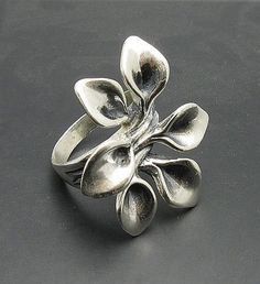 Sterling silver ring 925/1000, flower. Stamped 925.Approximate weight 11.6 grams. Top width 3.3 cm (1.24 inches). All our jewels are made from solid sterling silver 925/1000 and are carefully crafted by hand in our family workshop. We dispatch your orders in 5 working days, worldwide and the postage is $5. We ship registered priority mail. Please allow 5-7 working days for delivery in Europe and 10-15 working days outside Europe. For any questions - please do not hesitate to contact me! Unique Silver Flower Shaped Ring, Silver Handmade Flower Ring For Formal Occasions, Silver Flower-shaped Ring For Formal Occasions, Handmade Silver Flower Ring For Formal Occasions, Silver Flower Shaped Hallmarked Rings, Sterling Silver Flower Ring With Polished Finish, Silver Flower Shaped Ring Stamped 925, Silver Sterling Silver Flower Ring With Polished Finish, Unique Silver Flower-shaped Jewelry