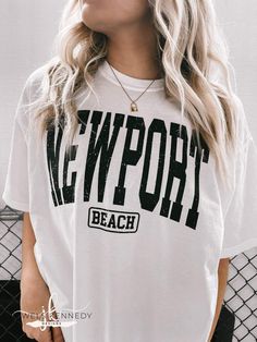 Newport Beach Comfort Colors Shirt - Jewels Kennedy Designs Leisure Crew Neck Tops For Beach Season, Vacation Graphic Tee Shirt With Letter Print, White Tops For Streetwear During Beach Season, Summer Short Sleeve Leisure Tops, Leisure Short Sleeve Summer Tops, Graphic Tee Shirt With Text Print For Beach Season, Sporty White Tops For Beach Season, Summer Letter Print Tops For Streetwear, Short Sleeve Tops For Beach Season Streetwear