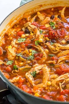 chicken tortilla soup in a large pot on top of the stove, ready to be eaten