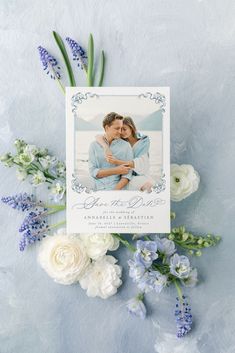 an image of a couple on their wedding day surrounded by flowers and greenery with the save the date card