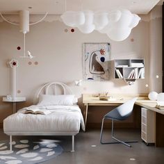 a white bed sitting in a bedroom next to a desk