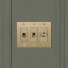 a light switch is shown with three knobs