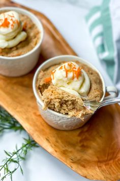 two desserts are sitting on a wooden platter