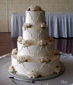 a three tiered wedding cake on a table