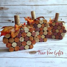 two wine cork pumpkins sitting on top of each other