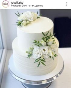 there is a white cake with flowers on it