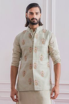 Mint green Nehru jacket with floral intricate hand embroidery and mandarin collar.
Component: 1
Pattern: Embroidered
Type Of Work: Floral
Neckline: Mandarin
Sleeve Type: Sleeveless
Fabric: Raw Silk, Cotton Silk
Color: Green
Other Details: 
Hand embroidery
Closure: Front concealed buttons
Note: Inner kurta and churidar worn by the model is not for sale
Occasion: Sangeet,Mehendi - Aza Fashions Embroidered Nehru Jacket With Stand Collar, Fitted Embroidered Nehru Jacket With Stand Collar, Embroidered Fitted Nehru Jacket With Stand Collar, Fitted Nehru Jacket With Floral Embroidery, Fitted Nehru Jacket With Floral Embroidery And Stand Collar, Spring Embroidered Nehru Jacket With Stand Collar, Traditional Bandhgala With Floral Embroidery And Stand Collar, Embroidered Nehru Jacket For Reception, Straight Shape, Embroidered Nehru Jacket For Reception