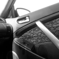 the interior of a car with black and white lace on the dash board, steering wheel and center console