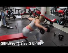 a woman doing squats in a gym