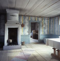 an empty room with a fireplace and table