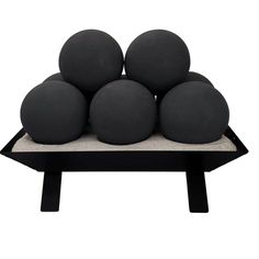 a group of black balls sitting on top of a table