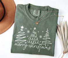 Comfort Colors Minimalist Merry Christmas Shirt Holiday Gift for Her Christmas Tree Tee Winter Graphic Comfort Colors t-shirt, a fully customizable tee made 100% with ring-spun cotton. The soft-washed, garment-dyed fabric brings extra coziness to your wardrobe while the relaxed fit makes it an excellent daily choice. The double-needle stitching throughout the tee makes it highly durable while the lack of side-seams helps the shirt retain its tubular shape. .: 100% ring-spun cotton .: Medium fabric (6.1 oz/yd² (206.8 g/m .: Relaxed fit .: Sewn-in twill label Bright Christmas Tree, Cute Christmas Shirt, Photo Care, Merry Bright Christmas, Cute Christmas Shirts, Tee Tree, Womens Christmas Shirts, Womens Christmas, Christmas Tree Shirt