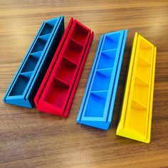 three plastic storage containers sitting on top of a wooden table