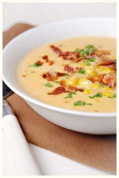 a white bowl filled with corn and bacon soup