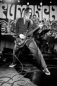 black and white photograph of a man playing an electric guitar