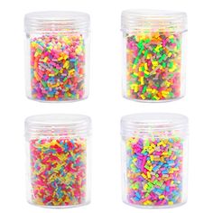 four jars filled with different colored sprinkles