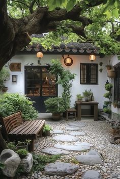 a stone path leads to a small white house with potted plants on either side