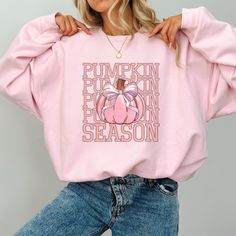 This super-soft fleece-lined Coquette Pumpkin Season Sweatshirt features a cute pumpkin and coquette pink bow. Printed on Gildan unisex sweatshirts for the ultimate in cozy comfort. Made for for those chilly days of the fall season! Please check the size charts for the perfect fit. Details: ✔ 50% ethically grown cotton, 50% polyester ✔ Medium-heavy weight fabric for the perfect amount of warmth ✔ Premium DTG prints - no peeling or cracking ✔ Classic fit in your regular size ✔ Easy care: Machine Cheap Pink Sweatshirt For Fall, Cute Letter Print Sweatshirt For Fall, Cute Fall Letter Print Sweatshirt, Cute Fall Loungewear Sweatshirt, Pink Sweatshirt For Fall Loungewear, Pink Crew Neck Sweatshirt For Fall, Pink Cartoon Print Sweatshirt For Fall, Cute Pink Fall Sweatshirt, Cozy Pink Fall Sweater