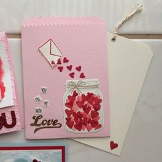 valentine's day cards with hearts in a jar and envelopes on the table