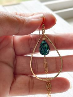 "The Alohi Earrings are made with 14 kt gold fill teardrop shaped hoops, ear wire and sparkly gold fill chain accents. The focal in the middle is a vibrant blue Paua shell teardrop and gold fill bead. These earrings hang about 3\" down from the bottom of the ear wire with the chain and 1 1/8\" wide." Nickel-free 14k Gold Filled Teardrop Earrings, Handmade Gold Teardrop Earrings, Hypoallergenic 14k Gold-filled Teardrop Dangle Earrings, Nickel-free Teardrop Earrings In 14k Gold Filled, Handmade 14k Gold-filled Teardrop Earrings, 14k Gold Filled Teardrop Earrings, Green Teardrop Hoop Earrings, Handmade 14k Gold Filled Teardrop Earrings, Green Teardrop 14k Gold Filled Earrings