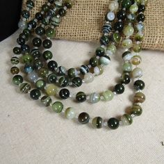 Multi-Strand Green Line Agate Beaded Necklace Green Agate Beaded Necklaces With Colorful Beads, Beads Necklace Ideas, Earthy Agate Beaded Necklace, Green Beaded Agate Crystal Necklace, Multi-strand Agate Beaded Necklace With Gemstone Beads, Multi-strand Agate Beaded Necklaces, Gray Beaded Necklace, Polished Crystals, Multi Strand Beaded Necklace