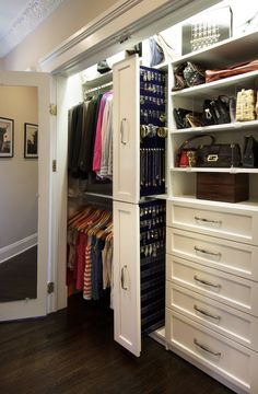 an organized closet with white cabinets and drawers