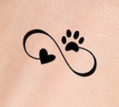 a dog paw and heart tattoo on the back of a woman's stomach