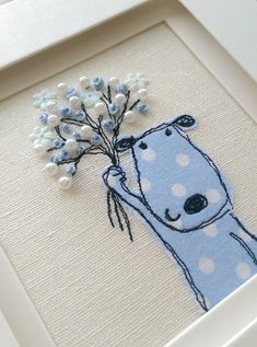 a blue bear with flowers in it's hand is shown on a white frame