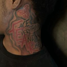 a man's neck with the words face everything and air painted on his chest