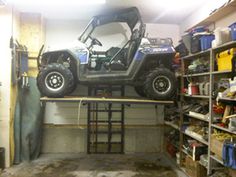 an atv is parked on top of a garage shelf