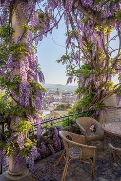 wister covered patio with table and chairs overlooking cityscape in the back ground