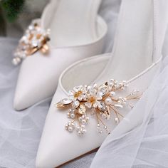 a pair of white wedding shoes with pearls on them