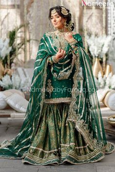 Pakistani Gharara Shirt in Green Bridal Dress is a perfect choice for traditional event. Beautiful embroideries as well as motifs and pearls work enhances its glamour and beauty. Bridal Gharara when paired with a classic mid length shirt in green color adorned with gold work creates a perfect outfit for mehendi. Shirt: This Green Bridal Dress has a beautiful shirt that has classic royal style and is beautifully embellished with gorgeous gold work around the neckline as well as on the long sleeve Green Gharara Pakistani Dresses, Green Garara Dress, Simple Mehendi Outfits For Bride, Green Pakistani Suit, Green Gharara, Pakistani Gharara, Shaadi Outfits, Bridal Gharara, Mehendi Dress