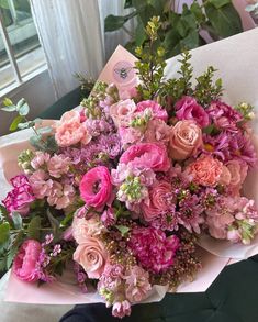 a bouquet of pink flowers sitting on top of a table