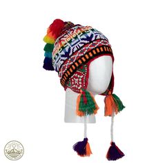 Immerse yourself in the vibrant spirit of the Andes with our meticulously crafted Beaded Shaman Ch'ullo. This unique winter hat is adorned with lively pom poms, playful tassels, and intricate beadwork, a true testament to the skill of indigenous artisans in Pisac, Cusco - PERU. The Ch'ullo is expertly woven with a rich palette of multicolored wool threads and features ear flaps for added warmth. Its captivating design proudly showcases the symbolic "Andean Llama," deeply rooted in the cultural h Traditional Adjustable Beanie Hat, Adjustable Rainbow Hat For Festivals, Funky Multicolor Hats For Festival, Funky Multicolor Festival Hats, Colorful Adjustable Festival Hats, Multicolor Bohemian Beanie Hat, Adjustable Multicolor Costume Cap, Bohemian Adjustable Bonnet For Festivals, Bohemian Multicolor Beanie