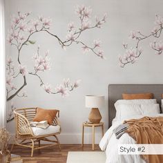 a bed room with a neatly made bed and flowers on the wall