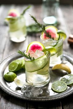 three glasses filled with watermelon, lime and cucumber garnish