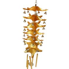 a golden wind chime with bells hanging from it's side