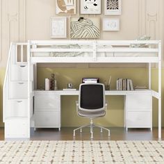 a white loft bed sitting under a desk next to a wall mounted art work area