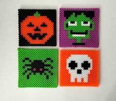 four halloween coasters made out of perler beads