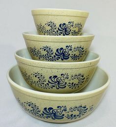 three bowls with blue designs are stacked on top of each other in front of a white background