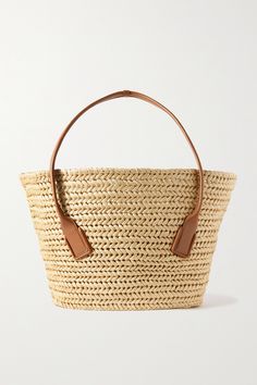 Bottega Veneta's tote is the ideal vacation accessory - the open-top is perfect for propping your towel and inside, there's enough room for your beach read, sunglasses and SPF. It's crafted from beige raffia with a tan leather trim and long shoulder straps. Designer Natural Straw Bag For Travel, Designer Summer Straw Bucket Bag, Luxury Natural Beach Bag, Designer Straw Bag With Handles For Vacation, Luxury Basket Straw Bag For Vacation, Luxury Natural Straw Bag For Beach, Designer Straw Bag With Intrecciato Weave For Vacation, Designer Rectangular Straw Bag For Summer, Luxury Natural Straw Beach Bag