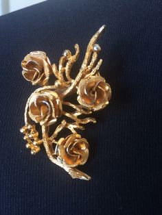 Beautiful vintage Coro brooch in gold tone and rose bouquet design. Signed Coro. Measures about 2 1/8 inches by 1 ¼ inches. In very good vintage condition. Please see this section of my shop for more vintage costume jewelry: https://www.etsy.com/shop/ChrisandTine?section_id=17309162 My full shop: http://www.chrisandtine.etsy.com Prices are listed for Canada and USA only but if you wish to have them shipped elsewhere, please message me the shipping address and I will gladly send you a quote. We p Vintage Rose Gold Brooches For Wedding, Vintage Rose Gold Wedding Brooches, Formal Gold Brooch With Rose Design, Gold Flower Brooch For Evening, Vintage Gold Flower Brooch, Vintage Gold Flower Brooches, Bouquet Brooch, Brooch Bouquets, Bouquet Design