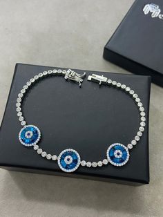 Silver Evil Eye Bracelet , Blue Stone Bracelet , Handmade Jewelry Bracelet , Good Luck Bracelet , 925K Sterling Silver Jewelry ,Gift For Him .. ★Item Details * Material : 925K Sterling Silver * Total weight : 12 Grams * Length : 18 Cm ✔ Ready to Ship in 1-2 Business Days .. ✔ Shipped to the Worldwide 1-5 business days with free shipping... ✔ The product will be sent to you with a handmade wooden box to avoid any damage during shipping... ✔ Visit our store, browse other Men's jewelry, silver and Blue Hand-set Bracelet As A Gift, Hand Set Blue Diamond Bracelet As Gift, Blue Cubic Zirconia Bracelet Gift, Blue Hand Set Diamond Bracelet As Gift, Blue Sterling Silver Bracelets, Blue Sterling Silver Round Bracelets, Blue Sterling Silver Diamond Jubilee Bracelet, Blue Cubic Zirconia Sterling Silver Bracelet Gift, Adjustable Blue Round Tennis Bracelet