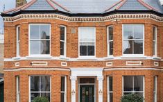 a large red brick house with white trim