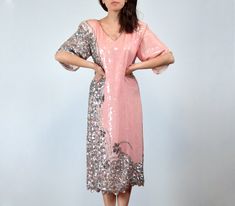 "Vintage 1980s fully sequined silk dress in pink and silver with an intricate bead and sequin design along the right side - You're sure to steal the scene! ✈ Measurements ✈ * Taken from SEAM to SEAM with garment lying flat *  Shoulder to Shoulder * 18\" Bust * 19.5\" Sleeve * 9.25\" Waist * 19\" Hips * 20\" Length * 45\" ✈ Specifics ✈ Label: Las Palmas, made by Papillon (made in India) Tagged Size: L Approx. Fit: Medium Color: Pink, Silver Material: 100% Pure Silk, Sequin, Beads Condition: A few missing sequins and beading throughout, overall in Good Vintage Condition ✈ Features ✈ * V neckline * Shoulder pads * Short peaked sleeves * Lower side slits * Fully embellished base (intricate bead and sequin design) - No zippers or fastenings, this goes on (and comes off) over your head . . . . . Pink Sequin Fabric For Spring Cocktail, Pink Sequin Fabric For Evening, Pink Embellished Sequin Dress For Festive Occasions, Festive Pink Embellished Sequin Dress, Pink Embellished Sequin Fabric For Cocktail, Pink Sequin Dress For Festive Occasions, Festive Pink Contrast Sequin Dress, Vintage Pink Sequined Dresses, Pink Vintage Sequin Dress