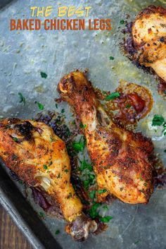 baked chicken legs on a baking sheet with parsley