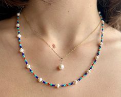 Inspired by the magnificent colours of the Mediterranean coast, this cheerful necklace is made with genuine, freshwater pearls (5 mm), 14k gold filled beads (2mm), and Turquoise, Lapis, and Coral coloured Miyuki glass beads. It is finished with a 14k gold filled spring ring clasp. 💎 LENGTH This necklace is 19 inches long. 💎 DETAILS * Handmade in Canada * Freshwater pearls (4-5 mm) *14k gold filled beads (2 mm) * Miyuki glass seed beads * 14k gold filled spring ring clasp  * Length: 19 inches ? Beaded Jewelry Necklaces, Gemstone Properties, Boho Choker, Beaded Necklace Diy, Gold Bead Necklace, Colourful Necklace, Freshwater Pearl Necklaces, Jewelry Inspo, Diy Necklace