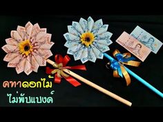 three different types of paper flowers with ribbons